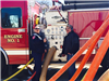 Two Officers Performing Maintenance on a Fire Engine 3