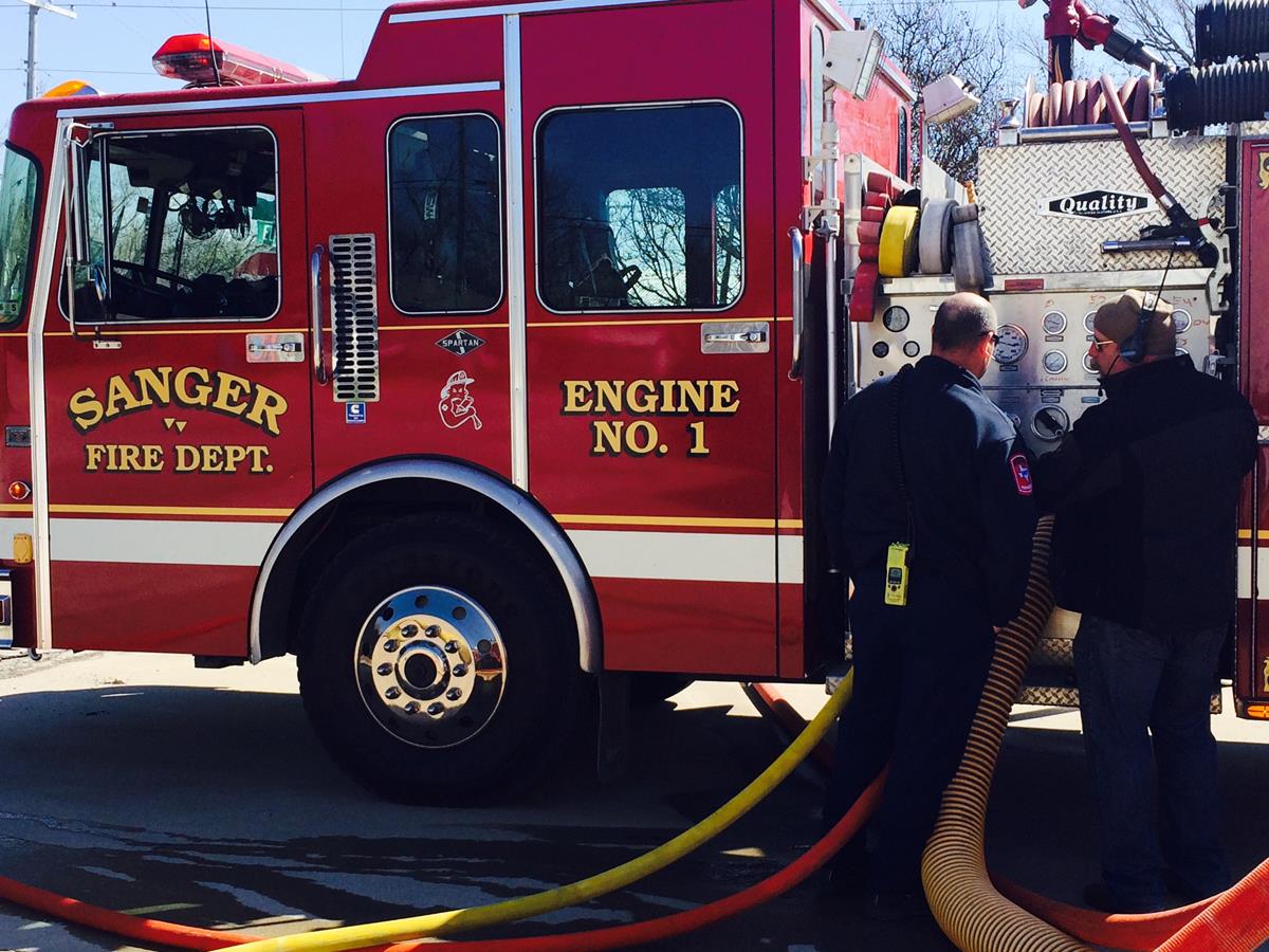 Two Officers Performing Maintenance on a Fire Engine 1