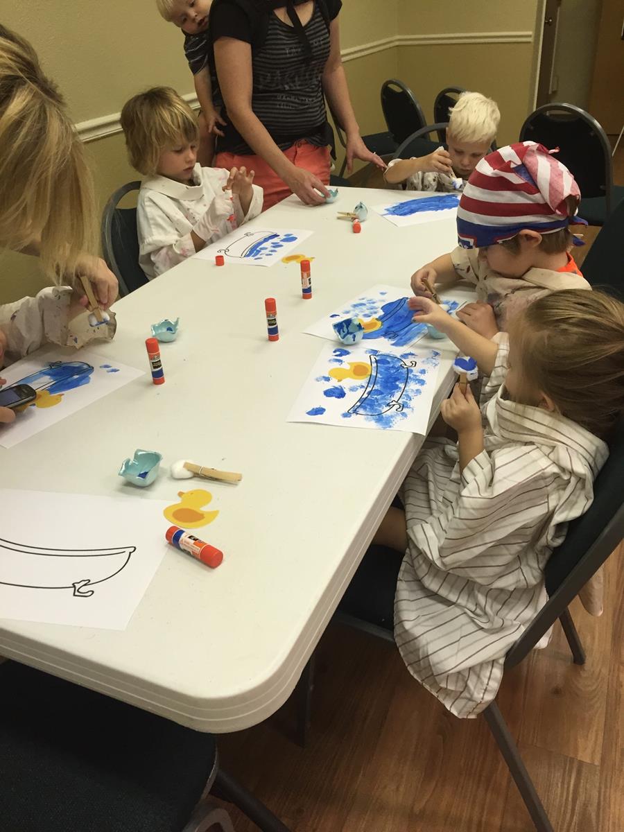 Kids Finger-Painting Rubber Ducks in a Tub